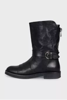 Boots decorated with leather straps