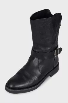 Boots decorated with leather straps