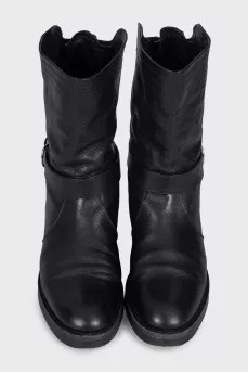 Boots decorated with leather straps