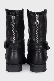 Boots decorated with leather straps