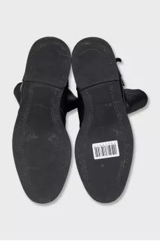 Boots decorated with leather straps