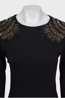 A straight dress decorated with crystals and beads