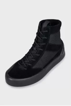 Black sneakers with suede inserts and a removable sole