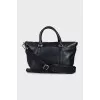 Leather bag with a textile strap