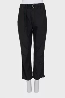 Black trousers with drawstrings on the legs