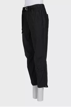 Black trousers with drawstrings on the legs