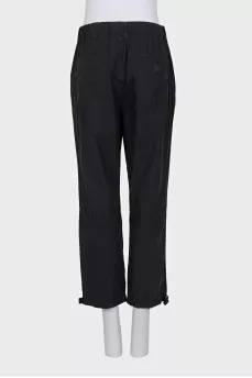 Black trousers with drawstrings on the legs