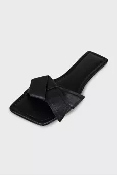 Black leather flip flops with a bow