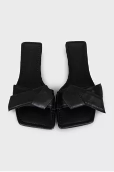 Black leather flip flops with a bow
