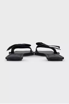 Black leather flip flops with a bow