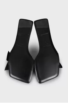 Black leather flip flops with a bow