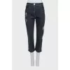 Gray capri pants with a distressed effect