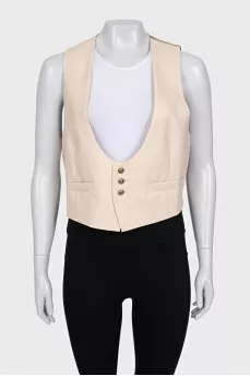 Beige vest with gold buttons and tag