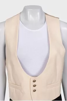 Beige vest with gold buttons and tag