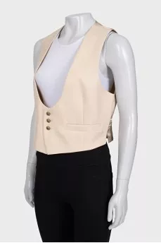 Beige vest with gold buttons and tag