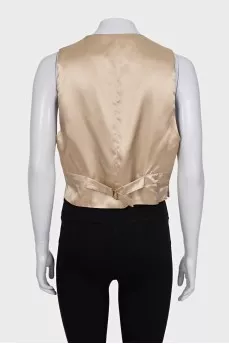 Beige vest with gold buttons and tag