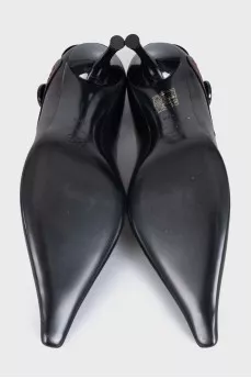 Black leather shoes with a button