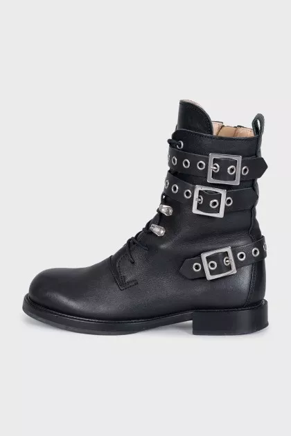 Leather boots decorated with straps