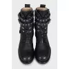 Leather boots decorated with straps