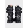 Leather boots decorated with straps