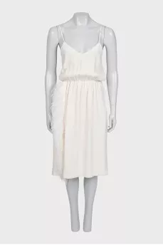 White dress with a cutout decorated with feathers