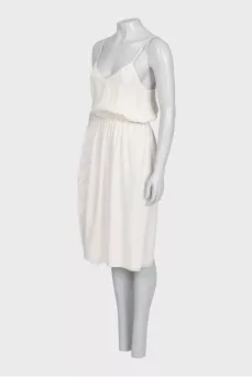 White dress with a cutout decorated with feathers
