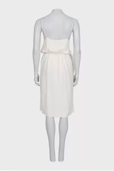 White dress with a cutout decorated with feathers