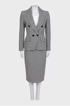 A suit consisting of a jacket, dress, and printed skirt