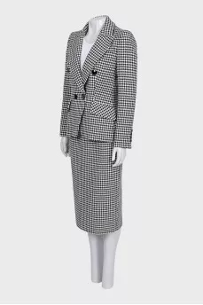 A suit consisting of a jacket, dress, and printed skirt
