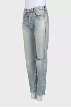 Tapered jeans with distressed buttons