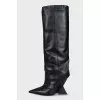 Black leather boots with a shaped heel