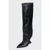 Black leather boots with a shaped heel