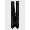 Black leather boots with a shaped heel