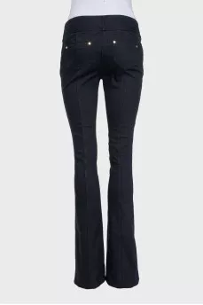 Black flared jeans with gold hardware