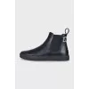Men's black boots with brand logo