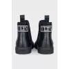 Men's black boots with brand logo