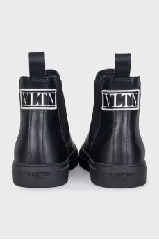 Men's black boots with brand logo