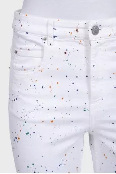 White jeans with a small multi-colored print