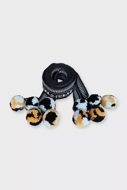 Blue textile belt with pom-poms