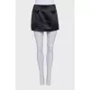 A suit consisting of a cropped jacket and a miniskirt