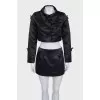 A suit consisting of a cropped jacket and a miniskirt