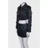 A suit consisting of a cropped jacket and a miniskirt
