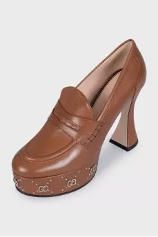 Brown shoes with a shaped heel and a tag