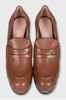 Brown shoes with a shaped heel and a tag