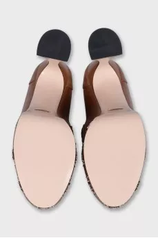 Brown shoes with a shaped heel and a tag