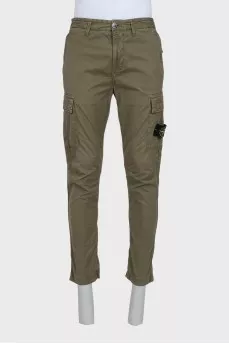 Men's green trousers with a branded patch