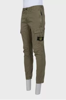 Men's green trousers with a branded patch