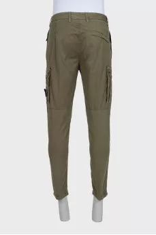Men's green trousers with a branded patch