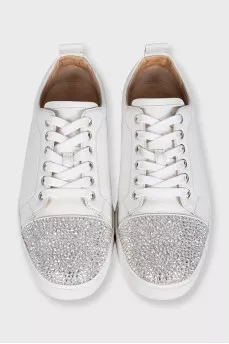 White sneakers decorated with rhinestones