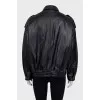 Slim-fit leather jacket with a zipper and buttons